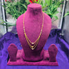 Gold necklace on a purple mannequin bust